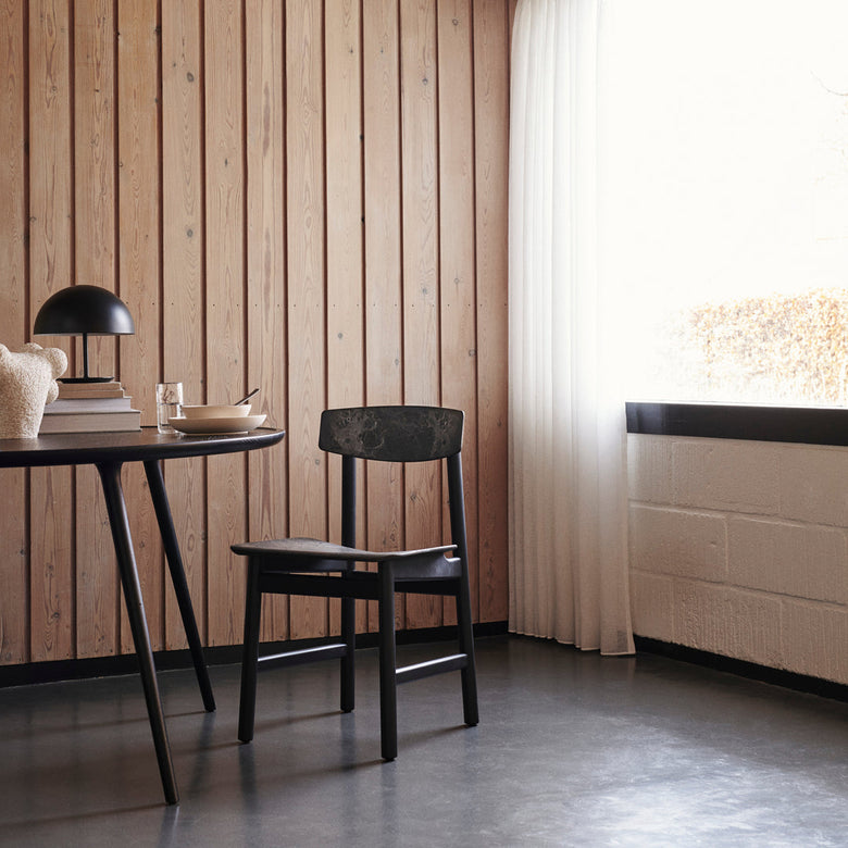 Conscious Chair 3162 in Black Stained Oak and Coffee Waste Black, in an interior setting