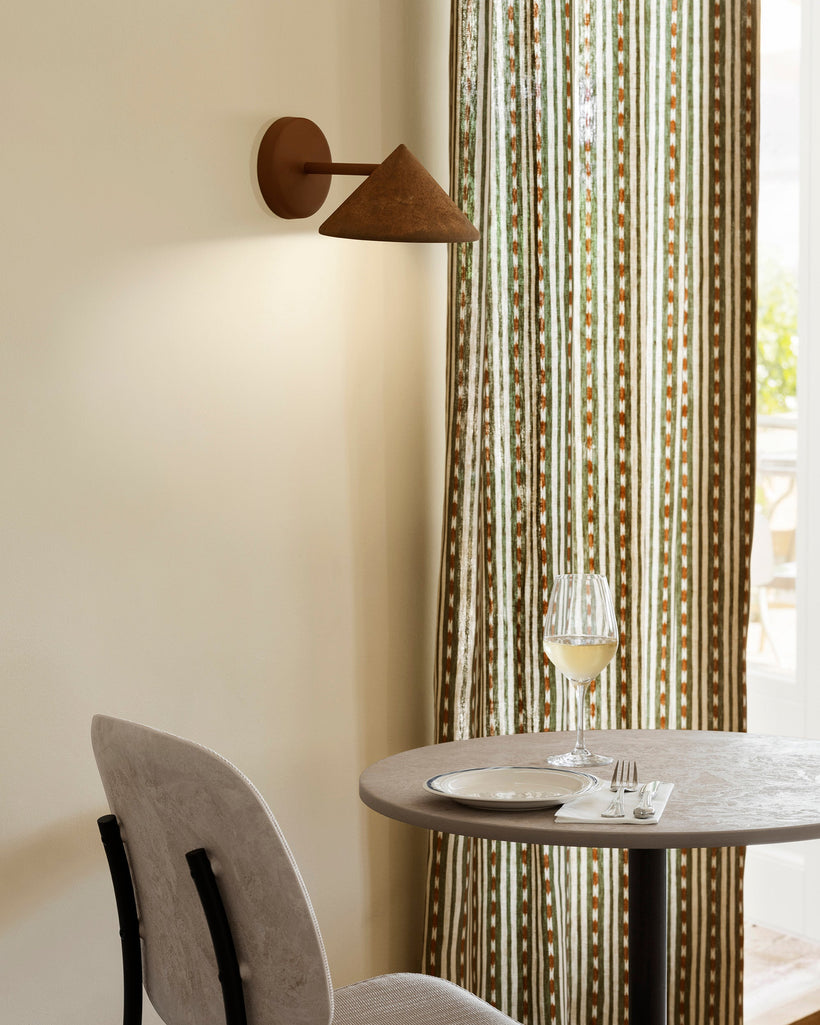 Mater_Terra Wall Lamp_Coffee Waste Rust Red_02552_Mater Table_11995_Lights on_SoMe Portrait.jpg__PID:77e593a9-bd0e-474d-99ec-6510f997238d