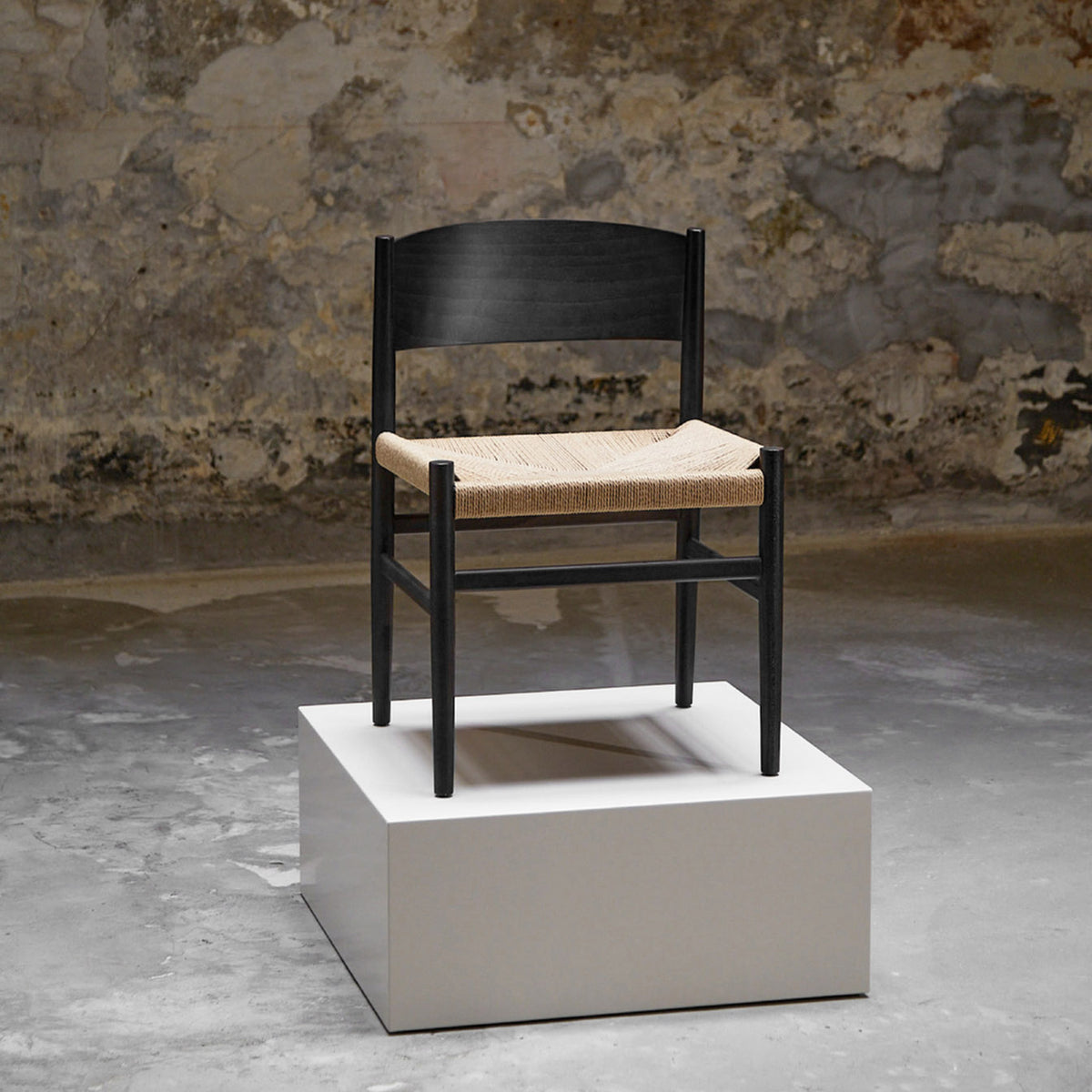 Nestor Sidechair in Black Beech with paper cord seat, in an interior setting
