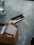 Mater Desktop in Coffee Waste Soft Black, setting on a height-adjustable base