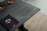 Mater Desktop in Coffee Waste Soft Black, setting with a desk chair in a workspace